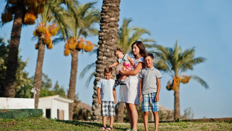 Family walking together under the palms — family therapy in Palm Beach County