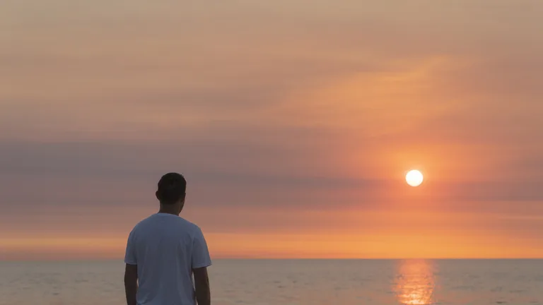 Man watching the sunrise over the Atlantic — substance use counseling in Florida